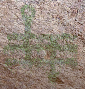 A faded magical symbol on sandstone